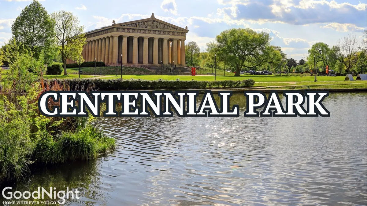An iconic exterior view of Nashville’s full-scale Parthenon replica, reflected on a serene water surface and surrounded by lush greenery. People can be seen walking, picnicking, or taking photographs, conveying a peaceful and culturally rich park setting.